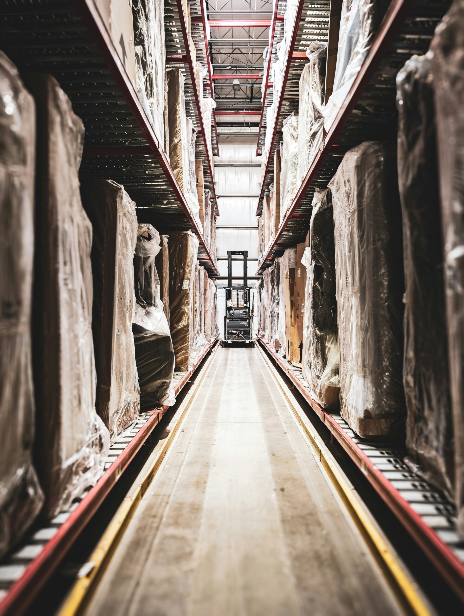 A train track in a large building with statues on it